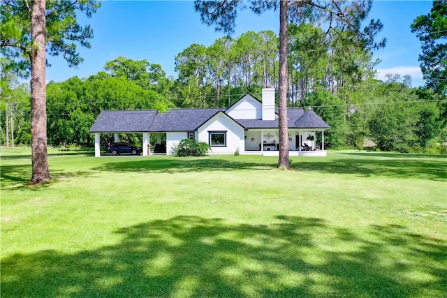 2204 Gibbs St, Waycross, GA 31503 - view of front of home with a chimney, a front yard, and view of scattered trees