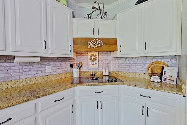 2204 Gibbs St, Waycross, GA 31503 - kitchen with crown molding, white cabinetry, decorative backsplash, and black electric cooktop
