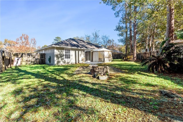 rear view of property featuring a yard