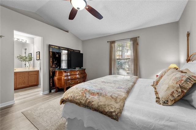 bedroom with connected bathroom, ceiling fan, light hardwood / wood-style flooring, a textured ceiling, and vaulted ceiling