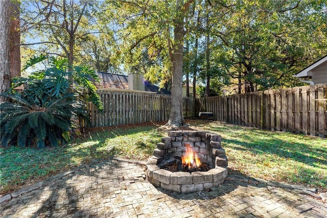 view of yard featuring an outdoor fire pit and a patio