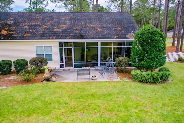 back of property with a patio area and a lawn