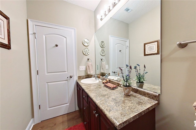 bathroom with vanity and hardwood / wood-style flooring