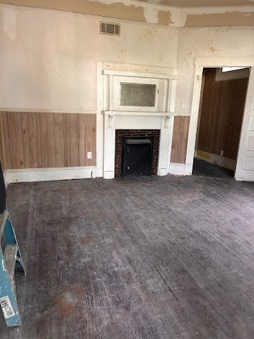 505 N Nicholls St, Waycross, GA 31501 - unfurnished living room featuring a fireplace, dark wood finished floors, and wooden walls