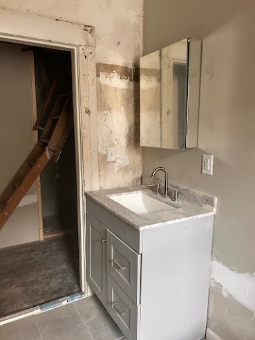 bathroom with tile patterned flooring and vanity