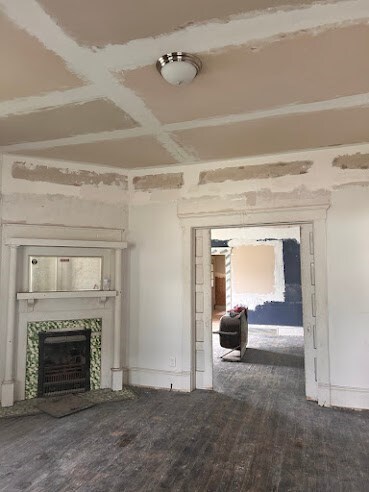 505 N Nicholls St, Waycross, GA 31501 - unfurnished living room featuring a tiled fireplace, wood finished floors, and beamed ceiling