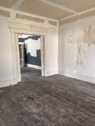 empty room featuring dark wood-type flooring