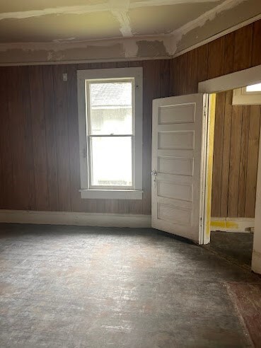 empty room with wood walls