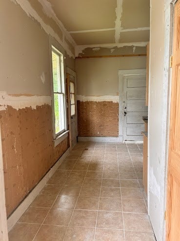 505 N Nicholls St, Waycross, GA 31501 - corridor featuring a wainscoted wall and tile patterned floors