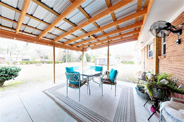 view of patio / terrace featuring outdoor dining space and an outbuilding