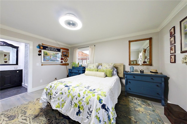 bedroom featuring baseboards, ornamental molding, wood finished floors, and ensuite bathroom