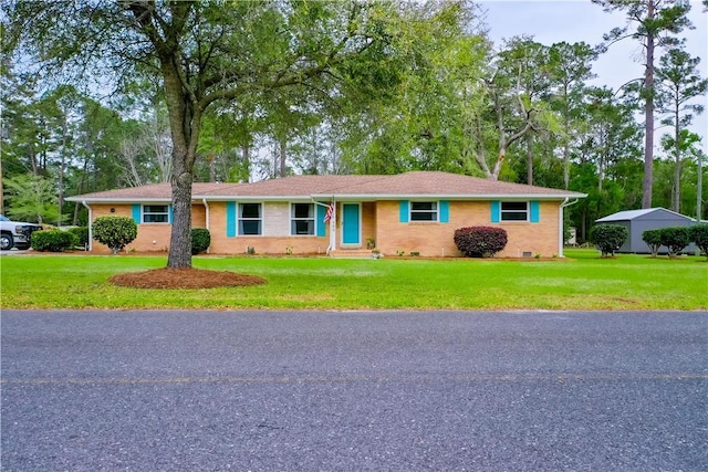 ranch-style house featuring brick siding, crawl space, and a front yard