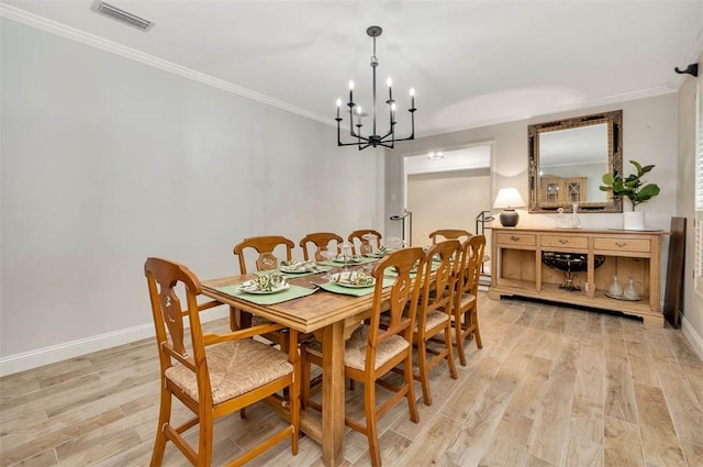 dining area with a chandelier, light hardwood / wood-style flooring, and ornamental molding