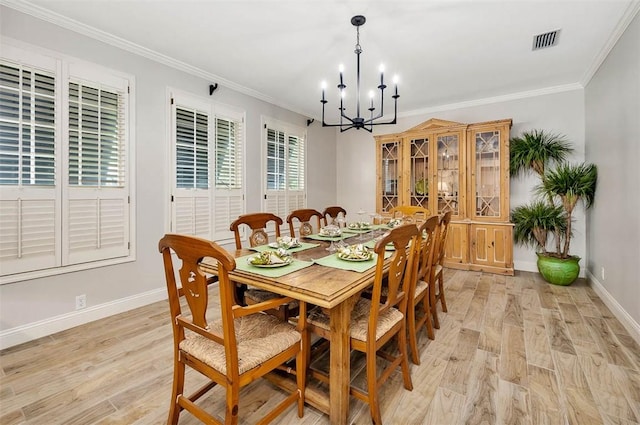 dining area with light hardwood / wood-style floors, an inviting chandelier, and ornamental molding