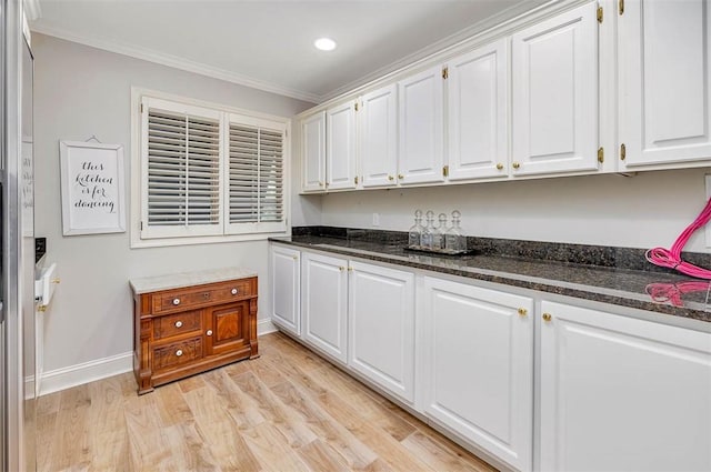 interior space with light wood-type flooring and ornamental molding