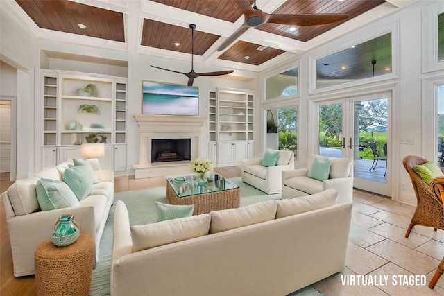 living room with coffered ceiling, light tile patterned flooring, wooden ceiling, and french doors