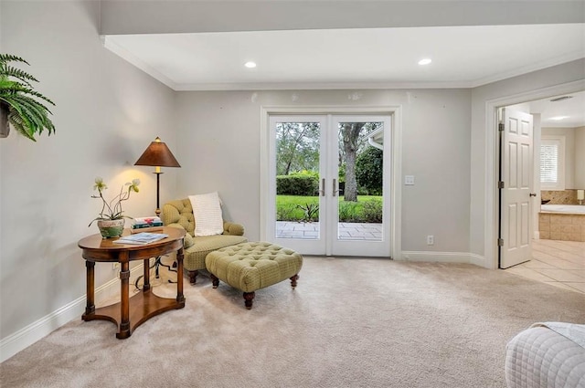 living area with french doors, light colored carpet, and ornamental molding