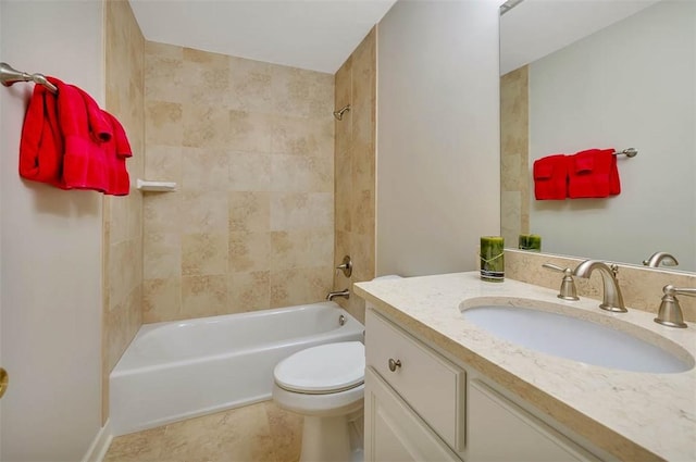 full bathroom featuring vanity, tiled shower / bath combo, and toilet