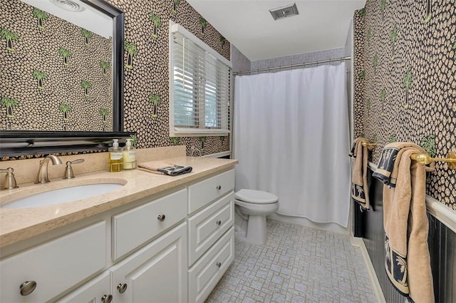 bathroom with vanity, a shower with shower curtain, and toilet