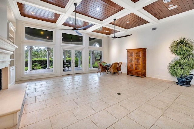 unfurnished living room with ceiling fan, wood ceiling, and coffered ceiling