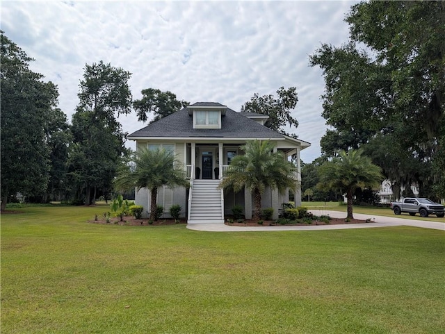 2115 Marshview Dr, Shellman Bluff, GA 31331 - raised beach house featuring stairway, a front yard, and covered porch