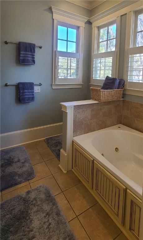 2115 Marshview Dr, Shellman Bluff, GA 31331 - bathroom featuring tile patterned flooring, plenty of natural light, a jetted tub, and crown molding