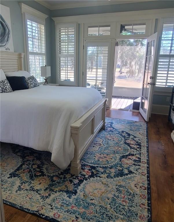 2115 Marshview Dr, Shellman Bluff, GA 31331 - bedroom featuring access to exterior, multiple windows, wood finished floors, and crown molding