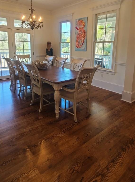 2115 Marshview Dr, Shellman Bluff, GA 31331 - dining area featuring ornamental molding, a chandelier, healthy amount of natural light, dark wood-style flooring, and french doors