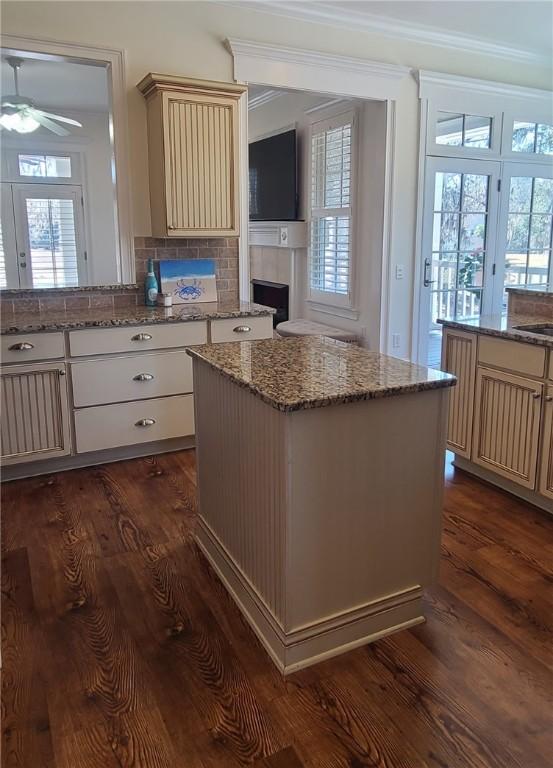 2115 Marshview Dr, Shellman Bluff, GA 31331 - kitchen with cream cabinetry, ceiling fan, dark wood-type flooring, plenty of natural light, and crown molding
