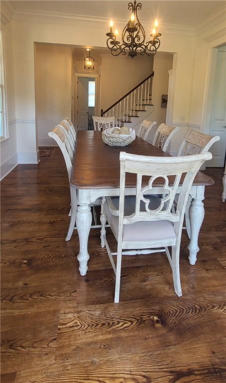 2115 Marshview Dr, Shellman Bluff, GA 31331 - dining space featuring wood finished floors, ornamental molding, a chandelier, stairway, and healthy amount of natural light