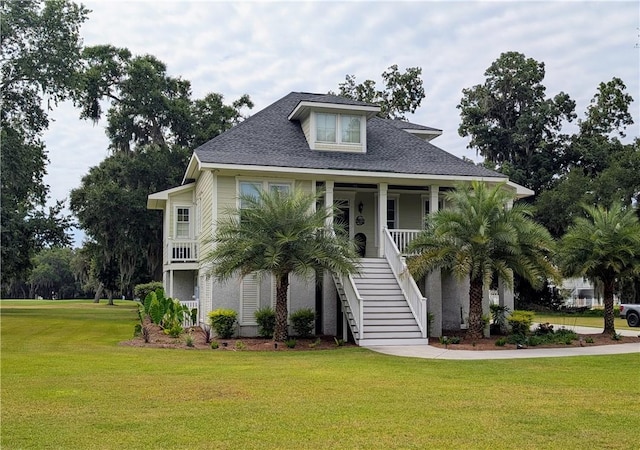 2115 Marshview Dr, Shellman Bluff, GA 31331 - coastal home featuring stairs, covered porch, a front lawn, and roof with shingles