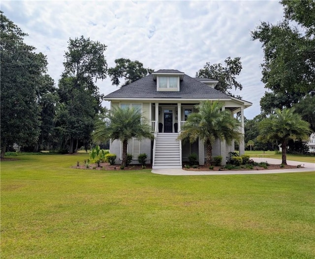 2115 Marshview Dr, Shellman Bluff, GA 31331 - view of front of house with stairway, a front lawn, and covered porch