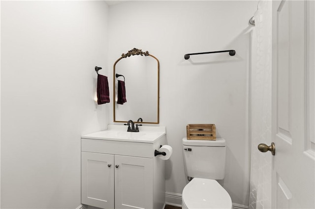 825 Red Hawk Dr, Waynesville, GA 31566 - bathroom with toilet, vanity, and baseboards