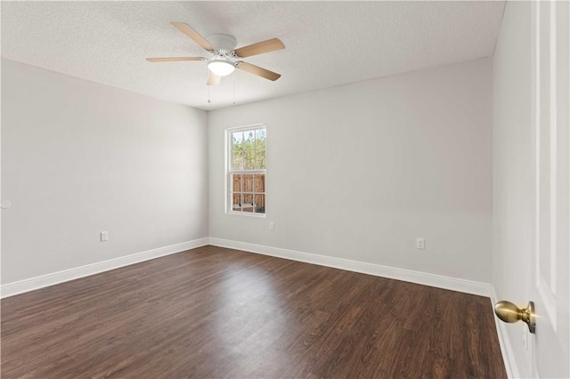 825 Red Hawk Dr, Waynesville, GA 31566 - spare room featuring dark wood-style flooring, a ceiling fan, baseboards, and a textured ceiling