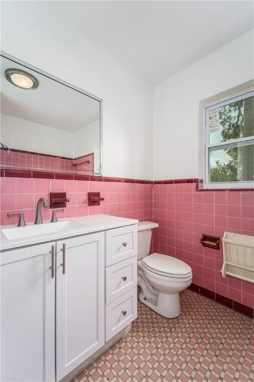 101 Forrest Ave, Waycross, GA 31501 - bathroom with tile walls, vanity, a wainscoted wall, and tile patterned floors