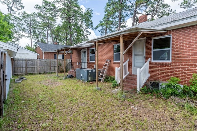 101 Forrest Ave, Waycross, GA 31501 - back of house featuring brick siding, a chimney, entry steps, and a metal roof