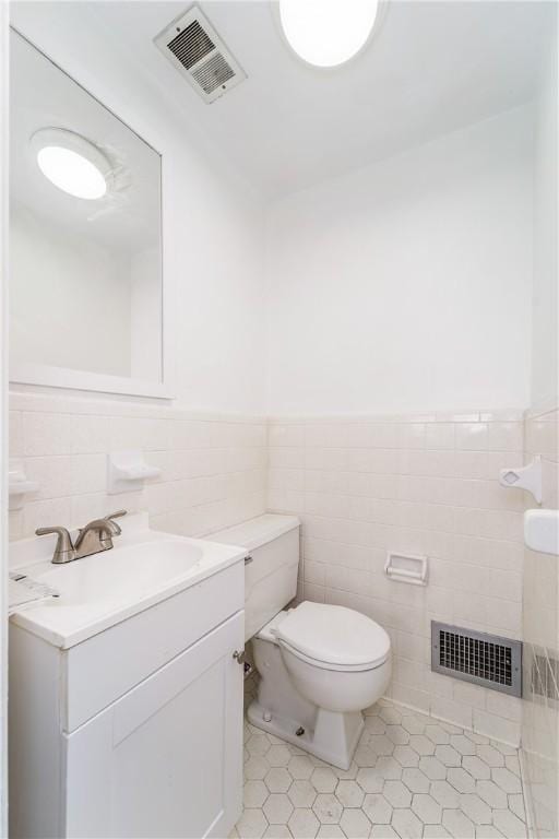 101 Forrest Ave, Waycross, GA 31501 - bathroom with tile walls, vanity, tile patterned flooring, and a wainscoted wall
