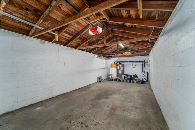 101 Forrest Ave, Waycross, GA 31501 - garage featuring concrete block wall, water heater, and a garage door opener