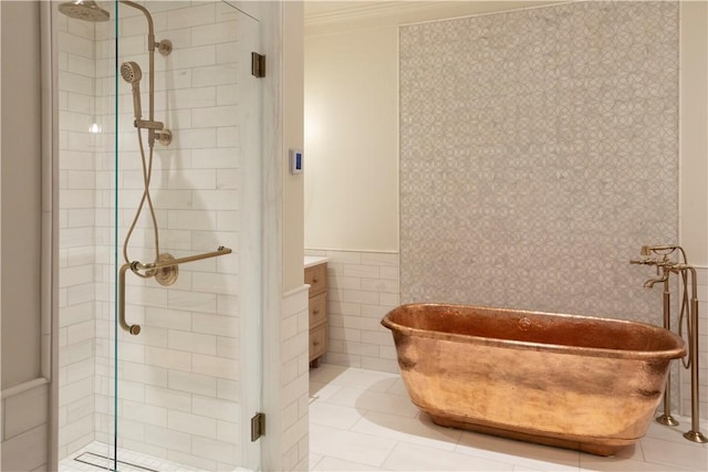 bathroom featuring ornamental molding, vanity, shower with separate bathtub, and tile walls