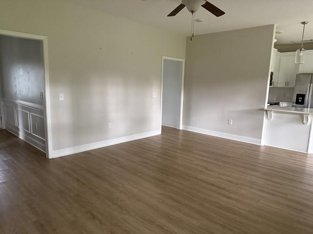 70 Harmonees Way, Ludowici, GA 31316 - unfurnished living room with a ceiling fan and dark wood finished floors