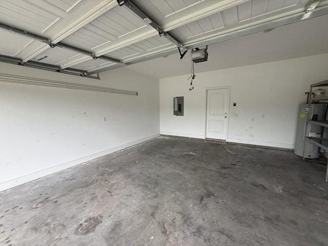70 Harmonees Way, Ludowici, GA 31316 - garage featuring electric panel, a garage door opener, and gas water heater