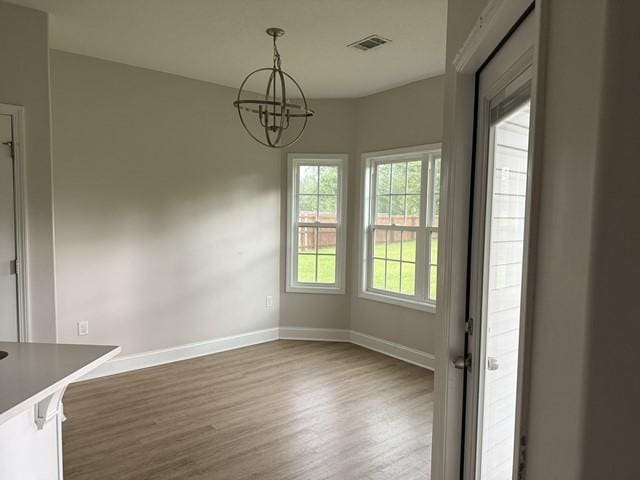 70 Harmonees Way, Ludowici, GA 31316 - unfurnished dining area featuring wood finished floors and a chandelier