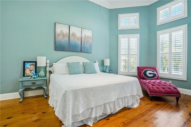 164 Sunrise Dr, Saint Simons Island, GA 31522 - bedroom featuring a towering ceiling, wood finished floors, and baseboards