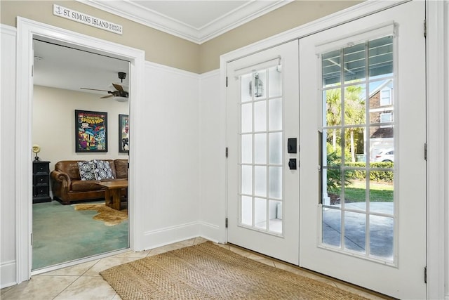 164 Sunrise Dr, Saint Simons Island, GA 31522 - doorway to outside with tile patterned floors, french doors, carpet flooring, ceiling fan, and crown molding