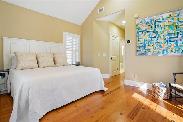 164 Sunrise Dr, Saint Simons Island, GA 31522 - bedroom with visible vents, baseboards, high vaulted ceiling, and light wood-style floors