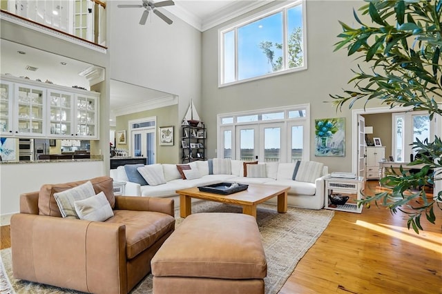 164 Sunrise Dr, Saint Simons Island, GA 31522 - living area featuring wood finished floors, ceiling fan, a high ceiling, ornamental molding, and visible vents