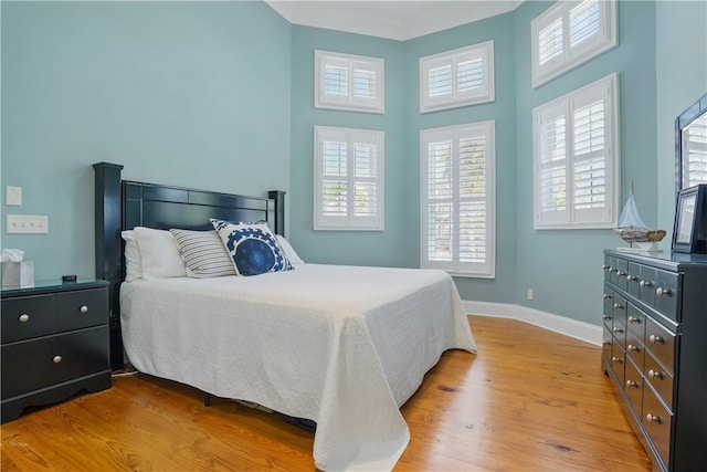 164 Sunrise Dr, Saint Simons Island, GA 31522 - bedroom featuring light wood-type flooring, baseboards, and a high ceiling