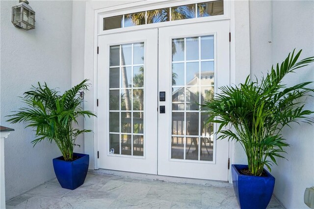164 Sunrise Dr, Saint Simons Island, GA 31522 - view of exterior entry with stucco siding and french doors