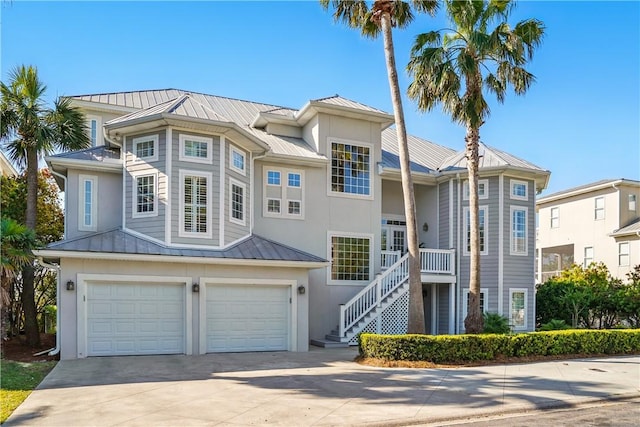 164 Sunrise Dr, Saint Simons Island, GA 31522 - view of front of house with stairway, metal roof, a standing seam roof, driveway, and a garage