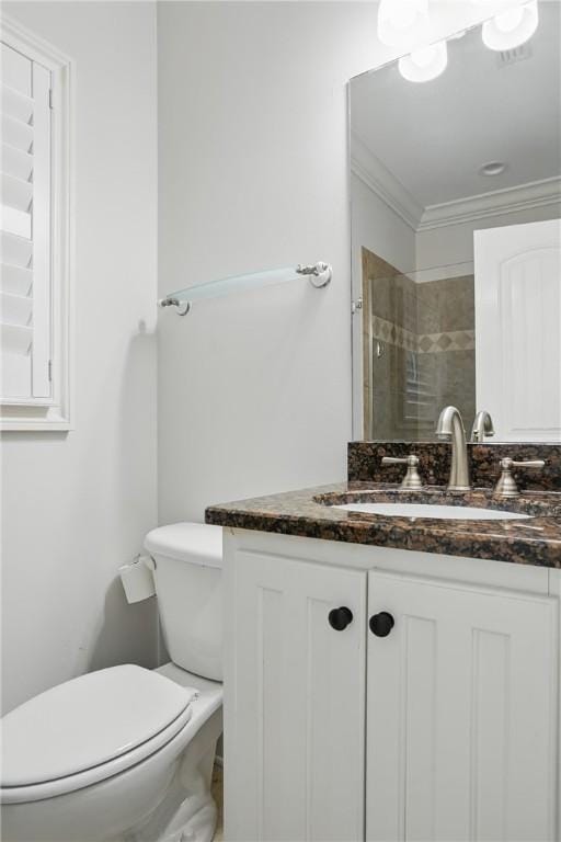 164 Sunrise Dr, Saint Simons Island, GA 31522 - bathroom featuring toilet, ornamental molding, vanity, and tiled shower
